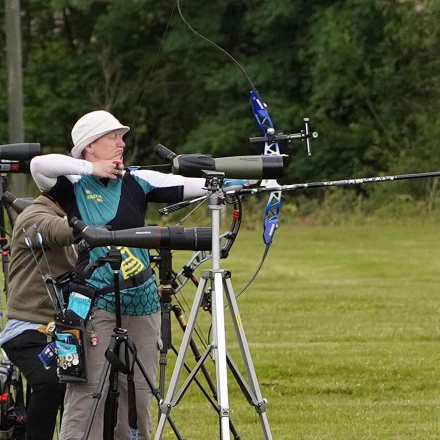 A Welbeck Archers member at full draw with a recurve bow, seen close up.